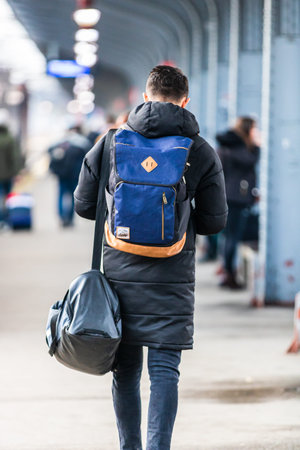 Young man with backpack on the train platform of Bucharest North Railway Station (Gara de Nord Bucharest) in Bucharest, Romania, 2020のeditorial素材
