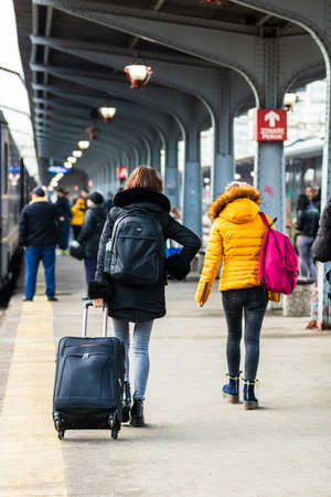 Travelers and commuters carry luggage and backpacks on the train platform of Bucharest North Railway Station (Gara de Nord Bucharest) in Bucharest, Romania, 2020のeditorial素材
