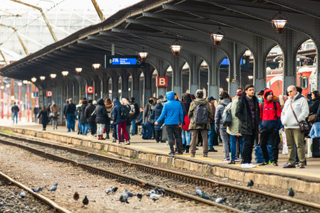 Travelers and commuters waiting for a train on the train platform of Bucharest North Railway Station...
