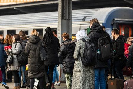 Travelers and commuters waiting for a train on the train platform of Bucharest North Railway Station...