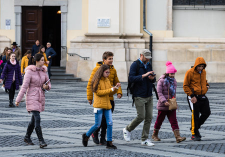 People and tourists wandering on the streets of Sibiu old town. Sibiu, Romania, 2020.のeditorial素材