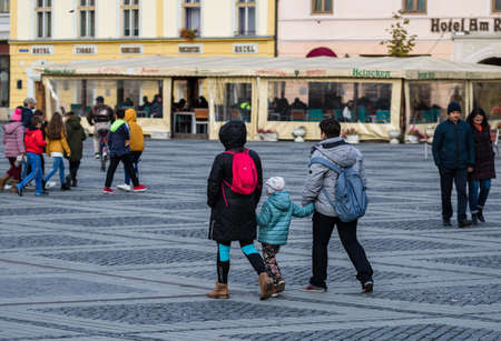 People and tourists wandering on the streets of Sibiu old town. Sibiu, Romania, 2020.のeditorial素材