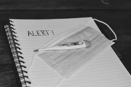 Writing Alert on spiral notebook.  Selective focus, Covid-19 flu disease virus spreading in Europe,...