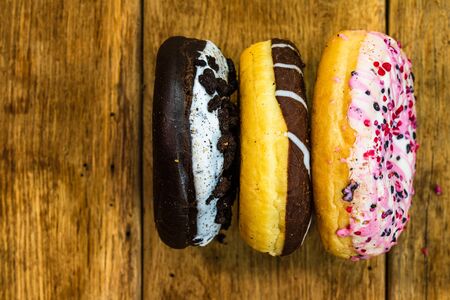 Colorful donuts on table with copy space. Top view of glazed doughnuts isolated.の写真素材