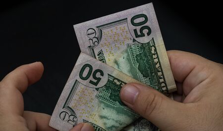 Man counting money, counting dollars close upの写真素材