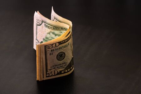 Money on the table, dollars on black tableの写真素材