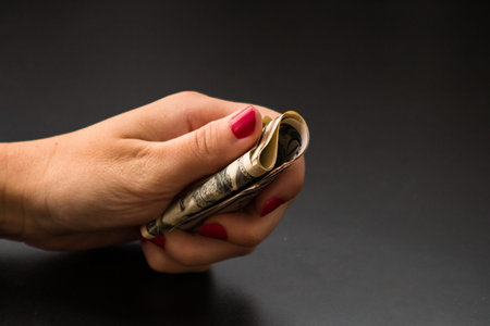 Woman counting money, counting dollars close up