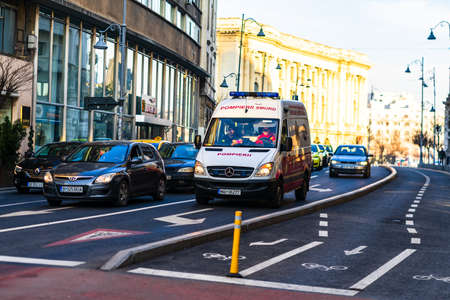 Romanian ambulance car, 911 or 112 emergency medical service in mission in downtown Bucharest, Romania, 2020. Coronavirus worldwide outbreak crisis. Spread of the COVID-19 virusのeditorial素材