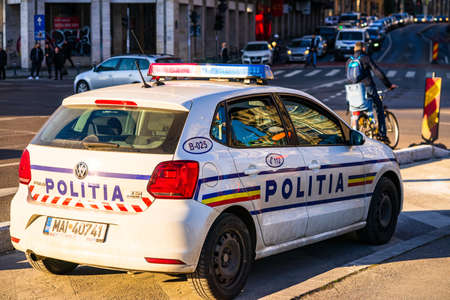 Romanian police (Politia Rutiera) car patrolling streets to avoid curfew breaches amid the spread of the COVID-19 in downtown Bucharest, Romania, 2020のeditorial素材
