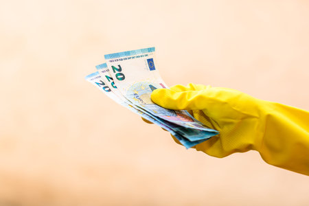 World money concept, hand with gloves receiving, giving or holding 20 EURO banknote, isolated on...