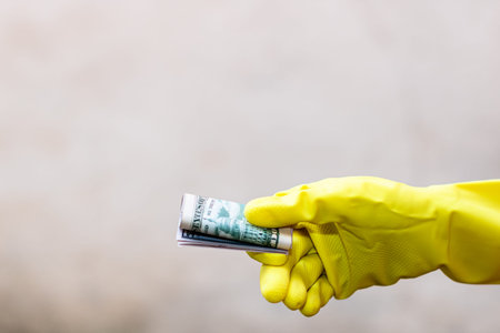 World money concept, hand with gloves receiving, giving or holding 50 USD banknote, isolated on...