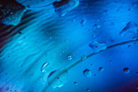 Abstract colorful backdrop with oil drops and waves on water surface. Abstract background conceptの写真素材