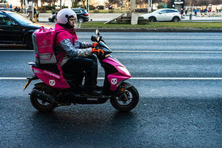 A Food Panda food delivery courier on a scooter. Restaurants are closed and only deliveries are...