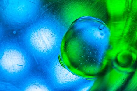 Abstract colorful backdrop with oil drops and waves on water surface. Abstract background conceptの写真素材