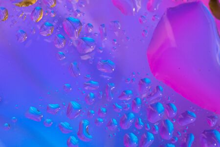 Abstract colorful backdrop or background with water drops on colorful surface. Abstract background conceptの写真素材