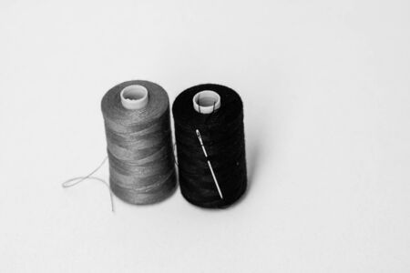 Black and white spools of sewing thread isolated, close upの写真素材