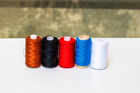 colorful spools of sewing thread isolated on white background