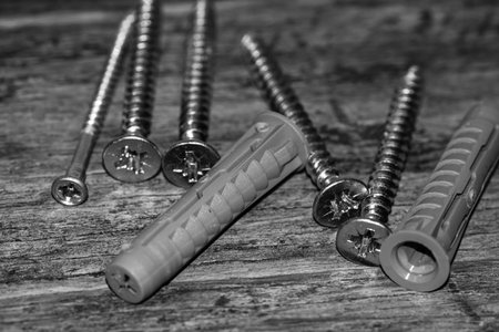 Close up photo of screws, set of screws in a construction abstraction. Industrial background with...
