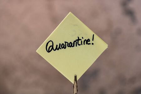 Quarantine handwriting text on memo post reminder isolated with copy space.の写真素材