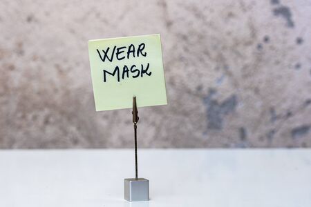 Wear mask handwriting text on memo post reminder isolated with copy space.の写真素材
