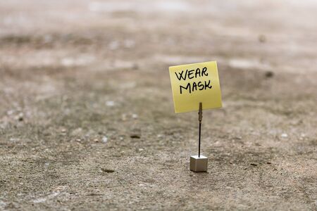 Wear mask handwriting text on memo post reminder isolated with copy space.の写真素材