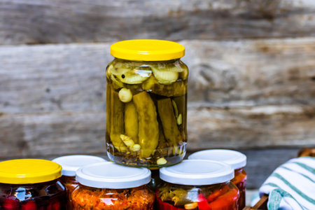 Jars with variety of canned vegetables and fruits, jars with zacusca. Preserved food concept in a...