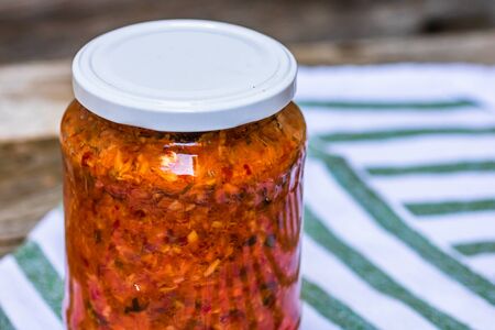 Glass jar with canned vegetables. Preserved food concept, canned vegetables isolated in a rustic composition.の写真素材