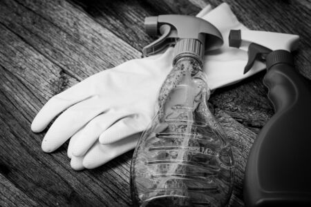 Cleaning sprayer anti bacterial sanitizer spray isolated with yellow gloves, concept of infection control.  Plastic bottle with dispenser for cleaning home or office with copy spaceの写真素材