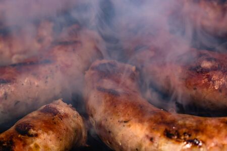 Close up on details of homemade sausages on barbecue grill. Barbecue, grill and food concept.の写真素材