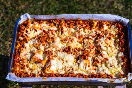 Close up and top view of a freshly baked homemade lasagna ready for serving.の写真素材