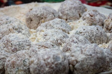 Raw meatballs coated in flour ready for frying.の写真素材