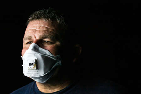 Man with protective 3M medical mask. 3M Aura 9312. The face mask used in the COVID-19 global pandemic as a protection against coronavirus in Bucharest, Romania, 2020のeditorial素材