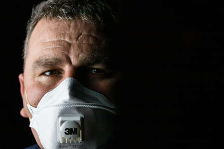 Man with protective 3M medical mask. 3M Aura 9312. The face mask used in the COVID-19 global pandemic as a protection against coronavirus in Bucharest, Romania, 2020のeditorial素材