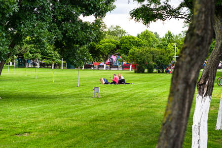 People walking, relaxing and have fun in park, freshly mowed grass.  Bucharest, Romania, 2020のeditorial素材