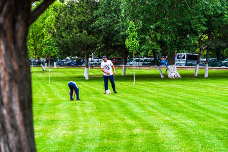 People walking, relaxing and have fun in park, freshly mowed grass.  Bucharest, Romania, 2020のeditorial素材