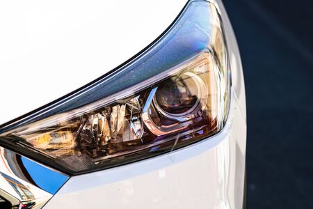 Close up photo of modern car, detail of headlight. Headlight car Projector LED of a modern luxury technology and auto detail.の写真素材