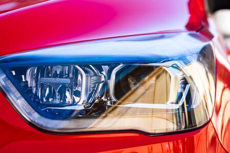 Close up photo of modern car, detail of headlight. Headlight car Projector LED of a modern luxury technology and auto detail.の写真素材