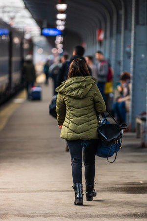 Travelers and commuters carry luggage and backpacks on the train platform of Bucharest North Railway Station (Gara de Nord Bucharest) in Bucharest, Romania, 2020のeditorial素材