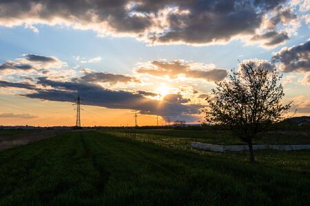 Beautiful sunset over a rural field, colorful sky.の写真素材