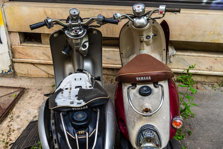 Vintage scooters stand deserted in an alley in old town of Bucharest, Romania, 2020のeditorial素材
