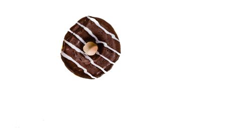 Colorful donut isolated on white. Sweet icing sugar food with glazed sprinkles, doughnut with frosting. Top view with copy spaceの写真素材