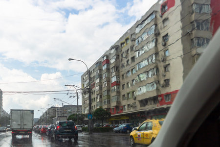 Traffic in cloudy rainy day with road view through car front window in Bucharest, Romania, 2020