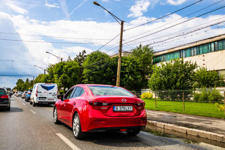 Traffic with road view through car front window, Red mazda 3 car in traffic. Bucharest, Romania, 2020のeditorial素材