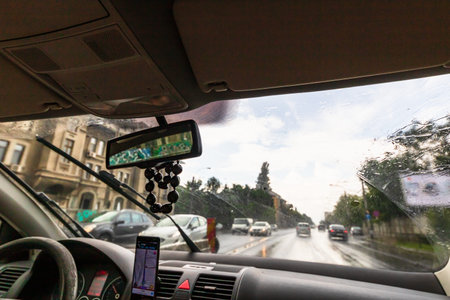 Traffic in rainy day with road view through car window with rain drops, blurry traffic on rainy day....