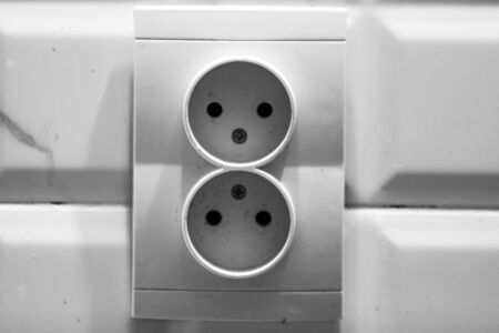White double socket on wall, electric plug close up isolatedの写真素材
