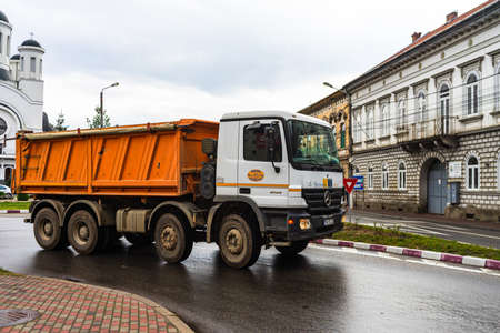 Old man riding a bike in downtown of Lugoj, Romania, 2020のeditorial素材