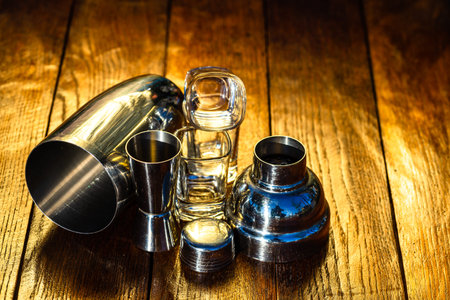 Bar ustensils, drink concept. Cocktail shaker accessories on a wooden board.
