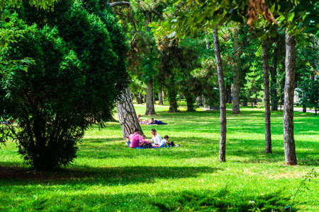 People having picnic relaxing and having fun during coronavirus crisis in park and gardens of the domain from Mogosoaia in Bucharest, Romania, 2020.のeditorial素材