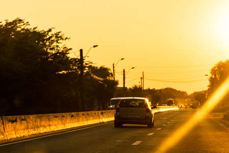 Car traffic at rush hour in downtown area. Traffic jam, cars on the road at sunset in Bucharest, Romania, 2020のeditorial素材