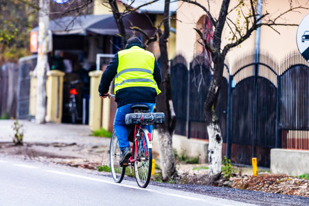 Man riding a bike in a village near Targoviste, Romania, 2020